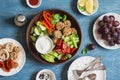 Vegetarian snack table - quinoa meatballs, fresh raw vegetables, grapes, dried fruits on wooden table, top view.