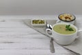 Vegetarian soup made of broccoli, potatoes, onions, garlic, sesame and olive oil, and coconut milk served in a wooden bowl. Royalty Free Stock Photo