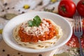 Vegetarian spaghetti on a white plate with a sauce with cheese