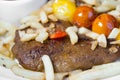 Vegetarian steak made from vegan seitan, cherry tomatoes and fries Royalty Free Stock Photo