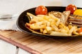 Vegetarian steak from vegan meat seitan, cherry tomatoes and fries Royalty Free Stock Photo