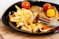 Vegetarian steak from vegan meat seitan, cherry tomatoes and fries Royalty Free Stock Photo