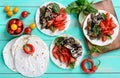 Vegetarian tacos with eggplant, cherry tomatoes, sweet peppers on a bright wooden background. Royalty Free Stock Photo