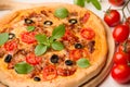 vegetarian pizza with tomatoes, olives and basil
