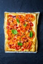 Vegetarian tomato tart or puffed pizza with herbs