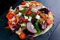 Vegetarian tortillas taco wrap with red onion, sweet cherry tomatoes, carrots, ruby chard, rocket and feta cheese