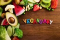 Vegetarian and vegan diet month in january called Veganuary. healthy raw vegetables and fruits on wooden background. Royalty Free Stock Photo