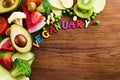 Vegetarian and vegan diet month in january called Veganuary. healthy raw vegetables and fruits on wooden background. Royalty Free Stock Photo