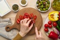 Vegetarian vegan food. Chopping tomatoes, cutting vegetables for greek salad horiatiki. Royalty Free Stock Photo