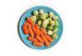 Vegetarian and vegan food on white. Baby carrots. brussels sprouts a plate Royalty Free Stock Photo