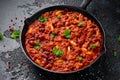 Vegetarian vegan mince chili con carne served in cast iron skillet pan