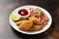 Vegetarian vegan southern fried nuggets served with sweet chilli sauce and cabbage salad