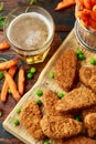 Vegetarian vegan southern style crispy nuggets served with sweet potato chips and beer