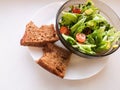 Vegetarian vegetable salad. Fresh salad flying to bowl in super slow motion. Avocado Tomato Salad Royalty Free Stock Photo