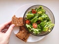 Vegetarian vegetable salad. Fresh salad flying to bowl in super slow motion. Avocado Tomato Salad Royalty Free Stock Photo