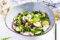 Vegetarian vegetable salad of radish, cucumbers, arugula and green onions. Royalty Free Stock Photo