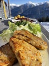 vegetarian version of the traditional Austrian knoedel served outside with a background view of snow capped mountains Royalty Free Stock Photo