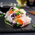 Vegetarian vietnamese spring rolls with spicy sauce, carrot, cucumber