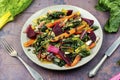 Vegetarian warm salad of stewed vegetables and chard leaves