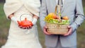 Vegetarian wedding. Autumn wedding details close up. Fiance with the bride at a picnic. Fruit basket and orange kettle.