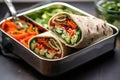 vegetarian wrap sandwich in a stainless steel lunchbox Royalty Free Stock Photo