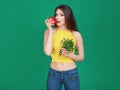 Vegetarian Young woman eating fresh raw vegetables salad pepper cucumber and parsley on green background. Healthy food Lifestyle D Royalty Free Stock Photo