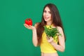 Vegetarian Young woman holding fresh raw vegetables salad pepper cucumber and parsley on green background. Healthy food Lifestyle Royalty Free Stock Photo