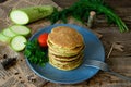 Vegetarian zucchini pancakes on a wooden background with natural yogurt, garlic and herbs. Vegetarian, healthy food.