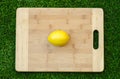 Vegetarians and cooking on the nature of the theme: lying on a cutting board and knife lemon yellow on the background of grass