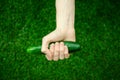 Vegetarians and fresh fruit and vegetables on the nature of the theme: human hand holding a cucumber on a background of green gras Royalty Free Stock Photo