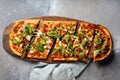 Vegeterian Pizza with pomegrnate seeds served in wooden board isolated on table top view of arabic breakfast