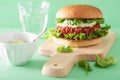 Veggie beet and quinoa burger with avocado dressing Royalty Free Stock Photo