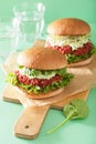 Veggie beet and quinoa burger with avocado dressing Royalty Free Stock Photo