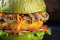 Veggie burger. Below lettuce. The cutlet consists of chickpeas, corn potatoes, fried onions and carrots Royalty Free Stock Photo