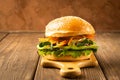 Veggie burger from fresh vegetablesand greens against dark background. The concept vegetable healthy food. Copy space. Royalty Free Stock Photo
