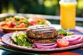 veggie burger with grill lines on a colorful platter