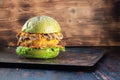 Veggie burger. lettuce. The cutlet consists of chickpeas corn potatoes, fried onions and carrots. mushroom. rusty baking stick. Royalty Free Stock Photo