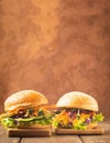 Veggie burger made from fresh vegetables and greens against a dark brown rustic background. Vertical frame. Copy space