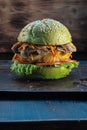 Veggie burger. rusty baking stick. wooden background. copyspace. Vertical orientation. close up Royalty Free Stock Photo