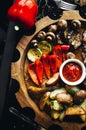 Veggie Succulent grilled vegetables with assorted sweet peppers, baby marrow and tomato garnished with herbs served in a