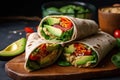 veggie wrap with hummus and avocado slices on warm flatbread