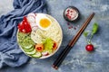 Veggies detox Buddha bowl recipe with egg, carrots, sprouts, couscous, cucumber, radishes, seeds. Top view, flat lay, copy space