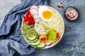 Veggies detox Buddha bowl recipe with egg, carrots, sprouts, couscous, cucumber, radishes, seeds. Top view, flat lay, copy space