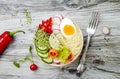 Veggies detox Buddha bowl recipe with egg, carrots, sprouts, couscous, cucumber, radishes, seeds. Top view, flat lay, copy space