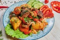 Veggy Succulent grilled vegetables with assorted sweet peppers, baby marrow and tomato garnished with herbs served in a