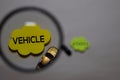 Vehicle or Autonomous write on a sticky note isolated on office desk. Selective focus on Vehicle text