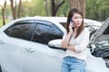 Young Asian woman calling assistance for her broken down car Royalty Free Stock Photo