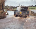 Vehicle Driving Through Flood Water On Road