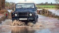 Vehicle Driving Through Flood Water On Road