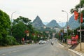 Vehicle driving on rural road with mountain background